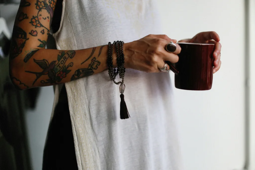 woman tattoo arm holding coffee cup