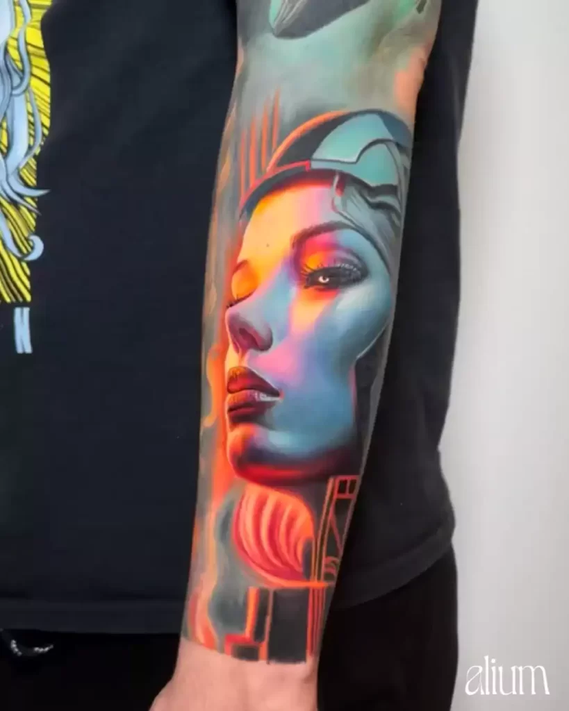 A vibrant tattoo of a woman's profile with neon-like orange and blue hues, blending realism with futuristic elements.